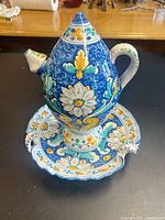 Front view of ewer on stand showing overall form and decoration