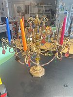Full view of candelabra with colored candles and hanging prisms