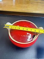 Top view showing lid, tape measure across diameter reading around 8–9 inches