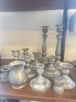 Group view of all pewter pieces on shelf