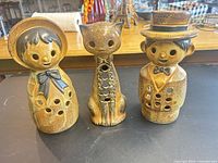 Three ceramic figurine tealight holders front view