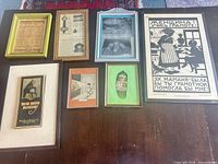 All seven framed pieces laid out on table for scale and comparison