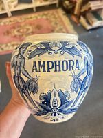 Front view showing “AMPHORA” text and floral design