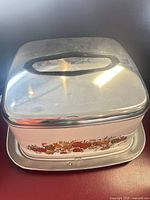 Front angled view showing body decal, chrome lid and tray