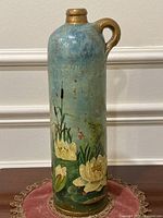 Front view showing floral painting and overall form
