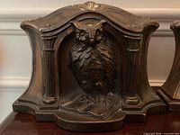 Front view of one owl bookend showing overall design and patina