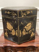 Front and side view of black and gold lacquered hexagon box