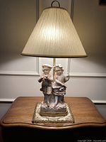 Full view of lamp on table with shade illuminated