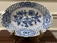 Front view of reticulated oval porcelain basket showing overall design and condition