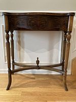 Front view of console table showing serpentine apron and legs