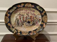 Front view of Royal Satsuma plate on stand showing full decoration