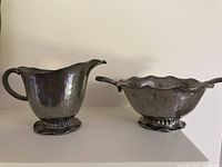 Creamer and sugar bowl side by side showing overall design