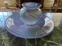 Wide shallow art glass bowl and rounded vase displayed together