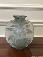 Front view of cameo-etched green leaf motif vase