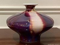 Front view of vase showing oxblood flambé glaze and bulbous shape