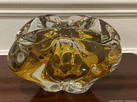 Front angled view showing amber core and clear glass form