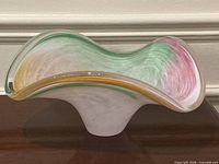 side view of Murano glass bowl showing ruffled rim and color swirls