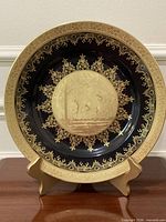 Front view of the gold encrusted plate on stand