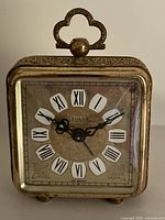 Front view showing dial, hands, Roman numerals, Solar logo