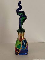 Full view of glass perfume bottle showing stopper and body