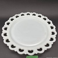 Front view of milk glass plate showing heart lace edge rim
