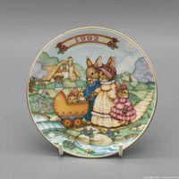 Front view showing 1992 rabbit family scene and gold rim