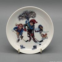 Front view of plate showing winter hockey scene illustration