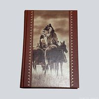 Front cover showing photographic panel and gilt border
