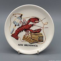 Front of ceramic plate showing lobster graphic and New Brunswick text
