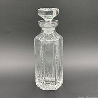 Front view of clear faceted crystal decanter with stopper