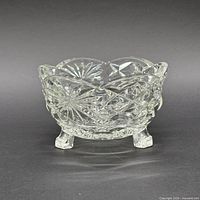 front view showing bowl shape, patterns, and three feet