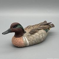 Left three-quarter view of the decoy showing head, chest and feather detail