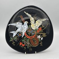 Full view of black porcelain plate with bird, floral and mandolin design