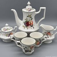 Full set showing teapot, creamer, sugar bowl with lid, and four cups