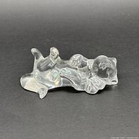 Top view of clear cat figurine lying on its back