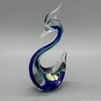 Full view of Murano glass swan showing blue-green coloration and clear glass form