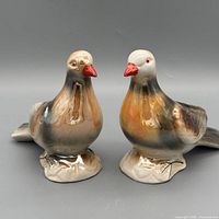 Front angled view of both bird figurines showing coloration and overall form