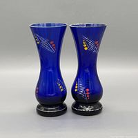 Front view of both cobalt blue vases showing design and bases