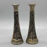 Front view of both embossed glass vases showing overall form and finish