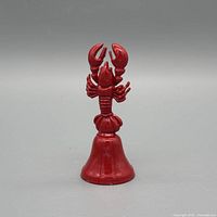 Front view of red painted lobster metal bell