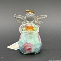 Front view of glass angel ornament with tag visible