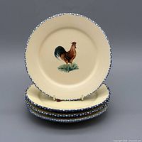 Stack of four rooster plates front view