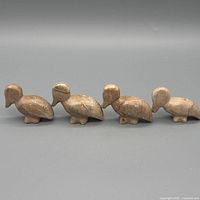 Front view of all four soapstone duck figurines