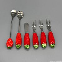 Full view of six utensils showing types and strawberry handles