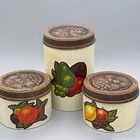 Front view of all three canisters displaying graduated sizes and fruit decals