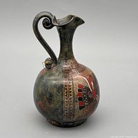 Side view showing full profile, handle, decorative bands and rooster motif