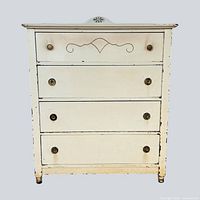 Front view of 4-drawer cream dresser with distressed finish