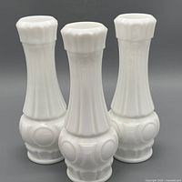 front view of all three matching white milk glass vases