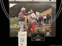 Front view of signed 8x10 photo in sleeve with COA card visible