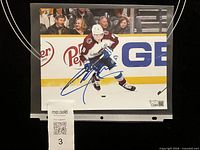Front of signed 8x10 photo showing Cale Makar, autograph, and protective sleeve